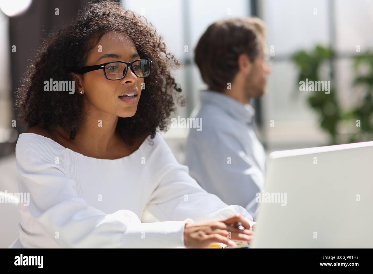 young attractive african american woman in the office Stock Photo - Alamy