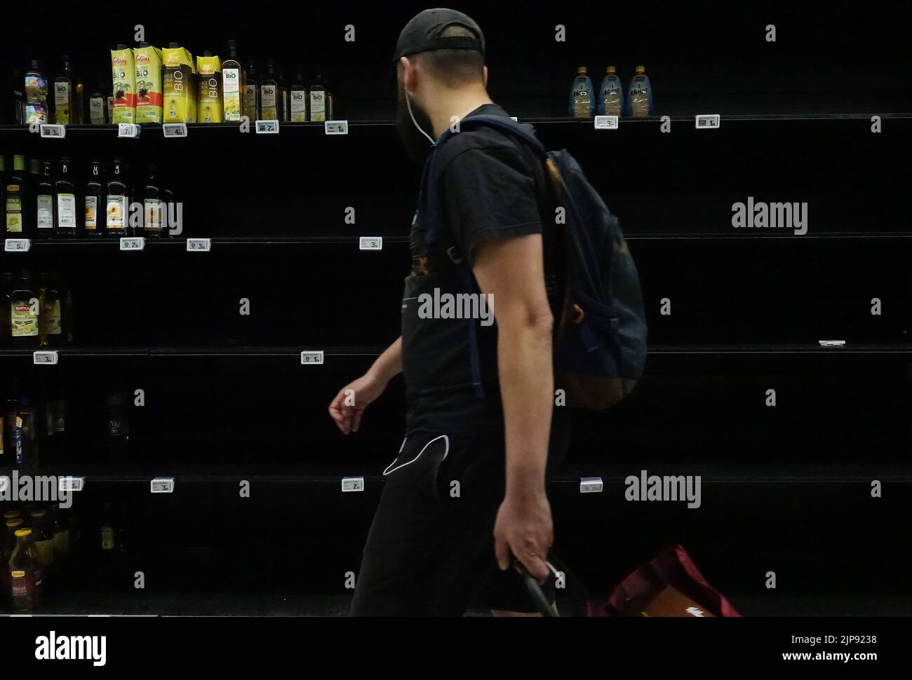 Brussels, France. 26th Mar, 2022. A customer walks past empty shelves of cooking oil at a supermarket in Paris, France, March 26, 2022. Credit: Gao Jing/Xinhua/Alamy Live News Stock Photo