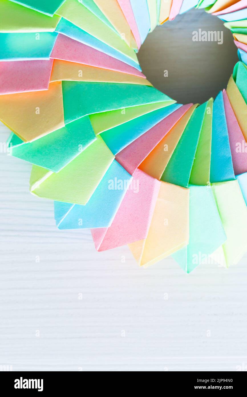 Origami ring, top view. Abstract parametric structure made of colorful paper sheets. Close up vertical photo with selective soft focus Stock Photo