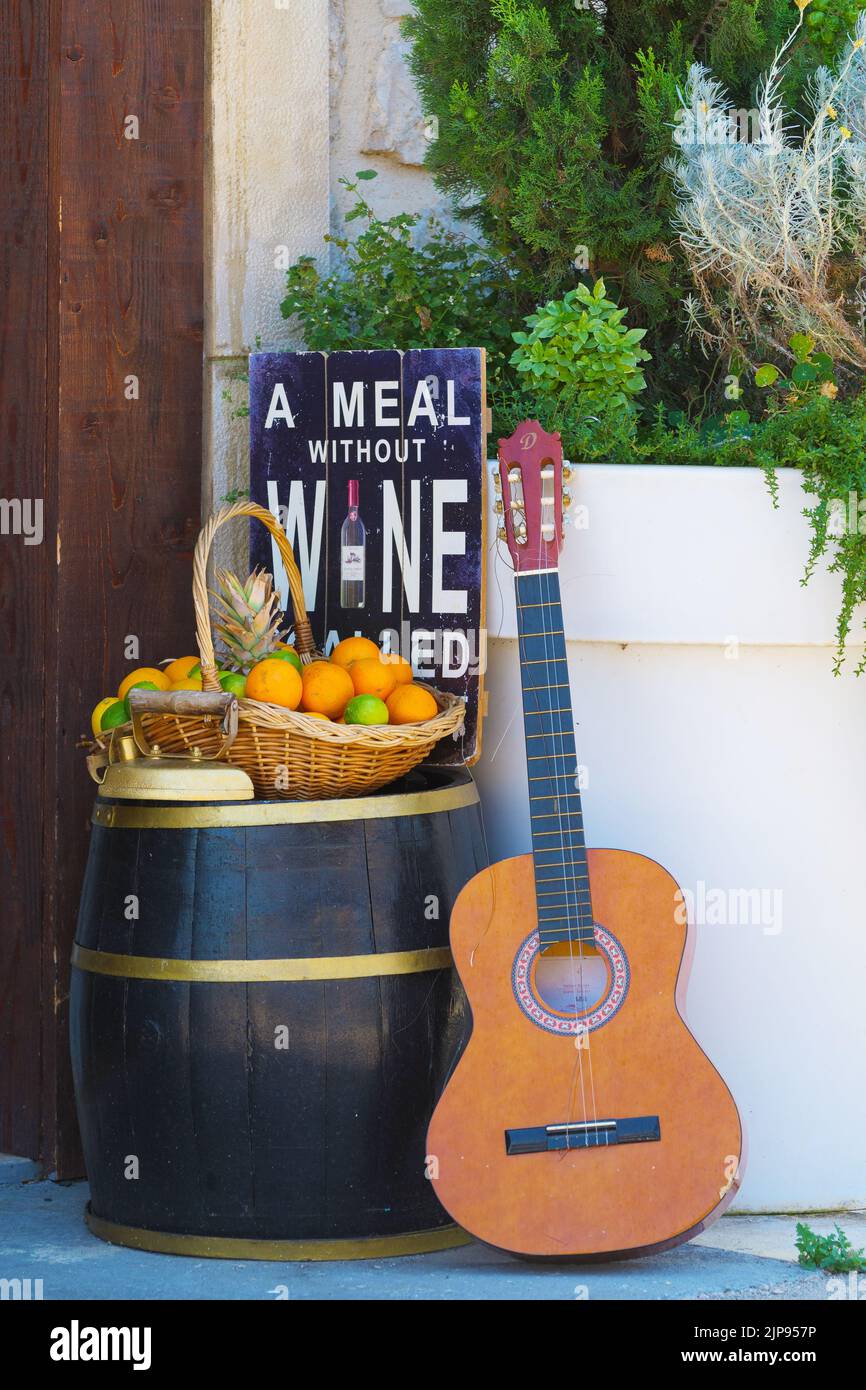 Classic guitar, wine barrel and basket with citrus fruit in a beautiful composition Stock Photo