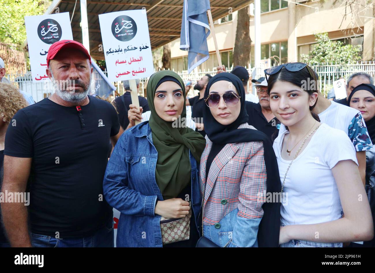 Atef al-Sheikh Hussein (red cap) asks the release of his brother Bassam al-Sheikh Hussein, deteinee in the headquarter of Intelligence Police Department in Beirut, Lebanon on August 16, 2022. On the same day at 1 p.m. Bassam al-Sheikh Hussein has been freed after the protests of man's lawyers, family, fellow depositors and common citizens. On August 11 Bassam al-Sheikh entered the Federal Bank in Hamra district, Beirut, with a gun and some fuel threatening to set himself on fire unless he was allowed to take out his own money. The man wanted to withdraw his 210.000 USD deposit, which was froze Stock Photo