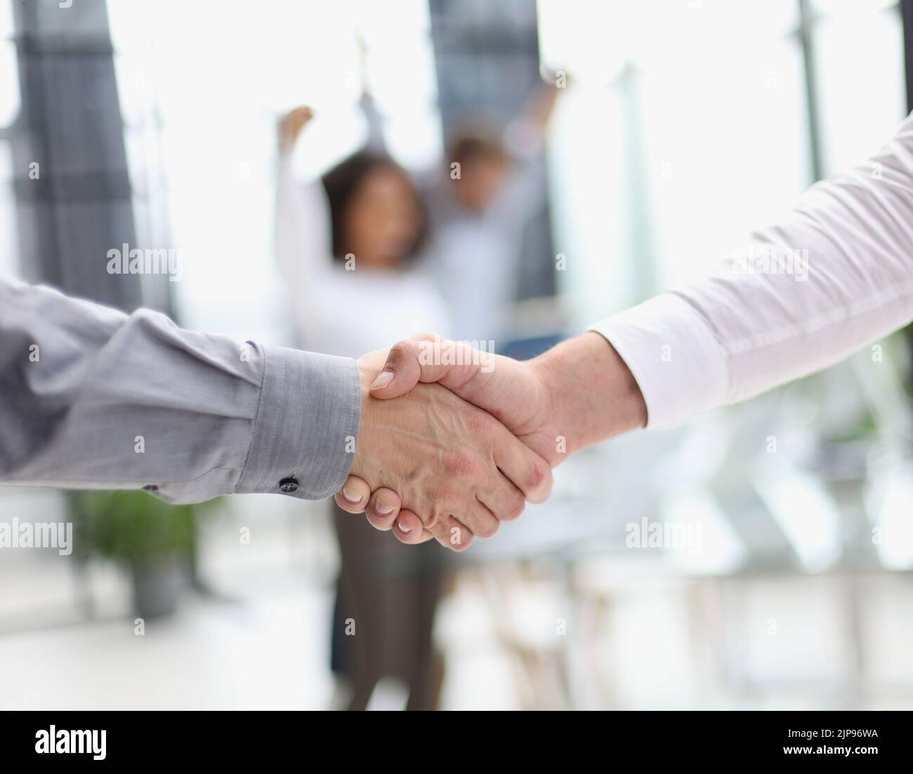 Close up people shaking hands on blurred background Stock Photo
