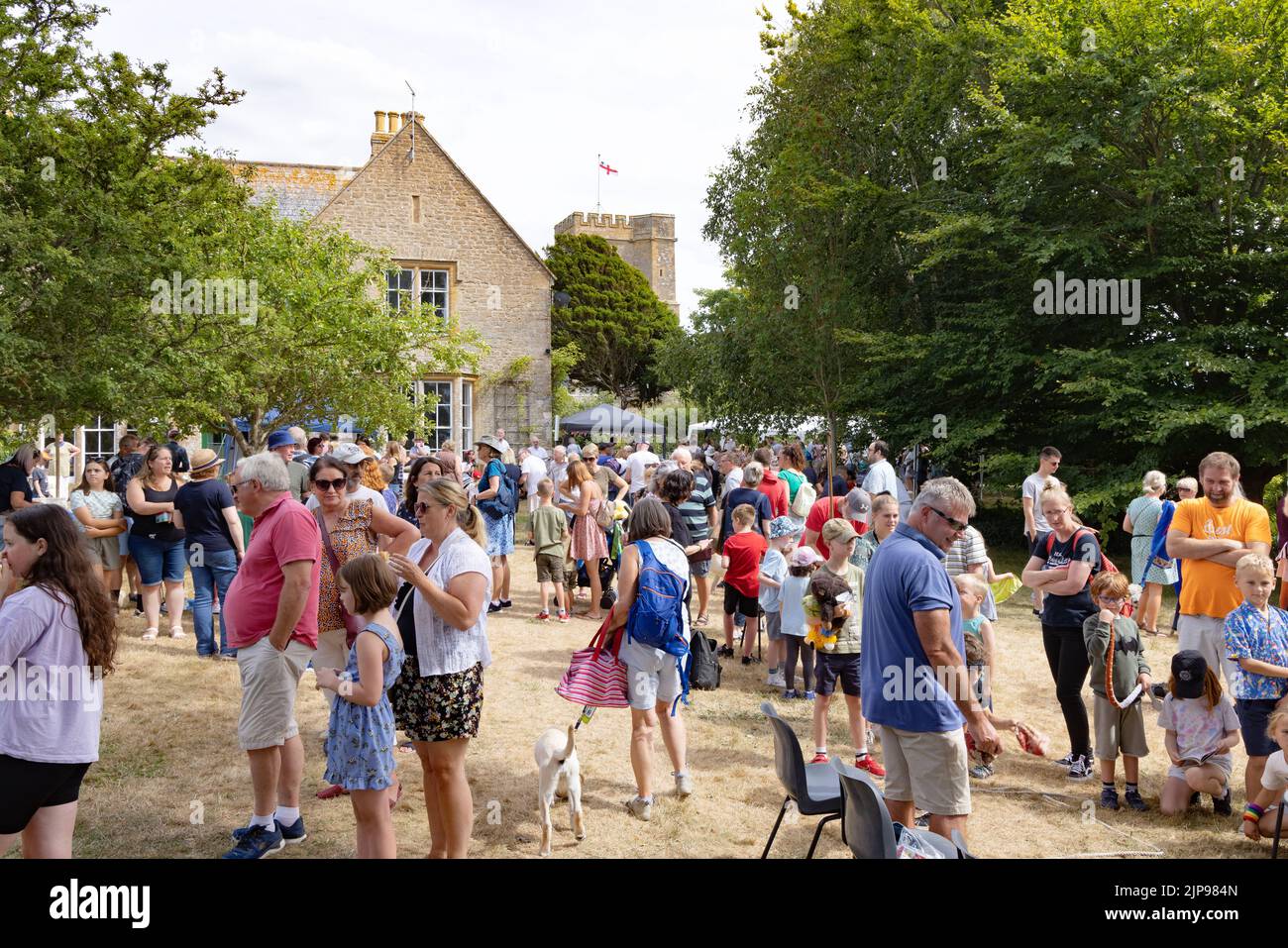 Village community UK; a crowd of village people at the annual Burton Bradstock summer fete, Burton Bradstock Village, Dorset UK Stock Photo