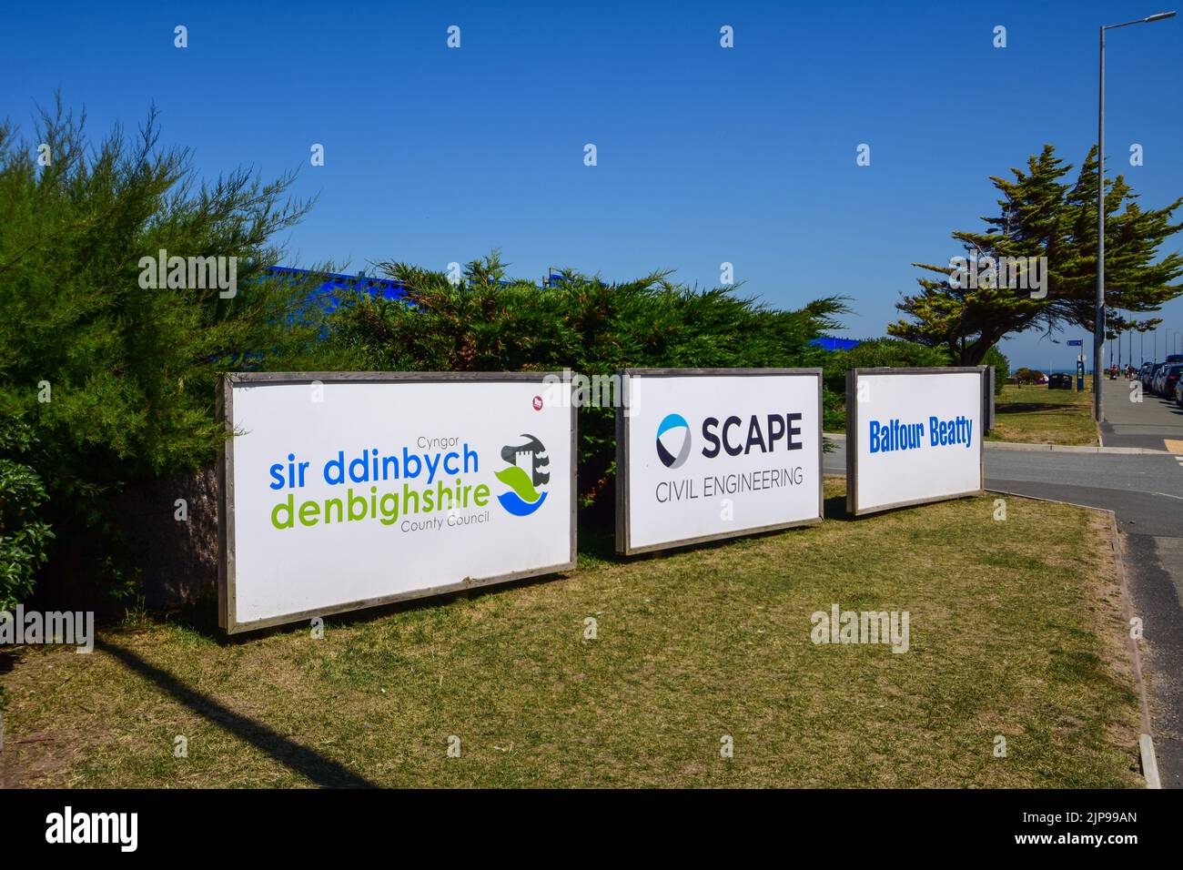 Rhyl, UK: Aug 11, 2022: Three wood framed signs at the entrance to a temporary works depot. Stock Photo