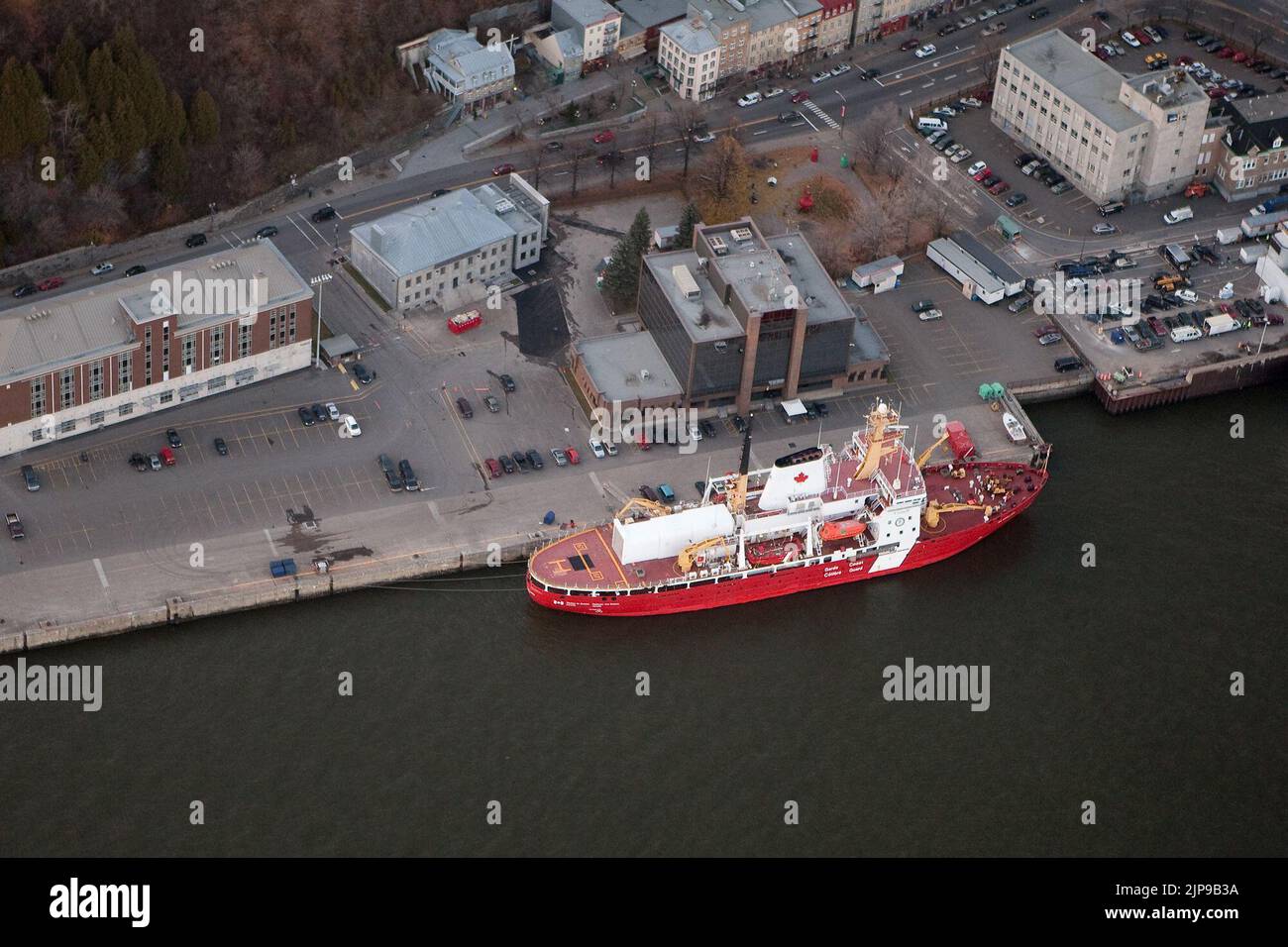 A Canadian coast guard ship is see at the Quebec city base in this aerial photo November 11, 2009. Canadian coast guard is the civilian federal agency responsible for providing maritime search and rescue (SAR), aids to navigation, marine pollution response, marine radio, and icebreaking. Stock Photo