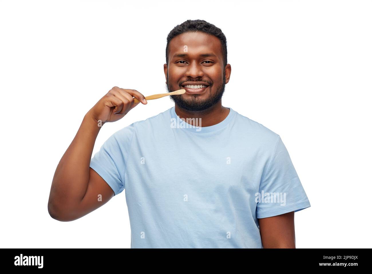 smiling african man with toothbrush cleaning teeth Stock Photo