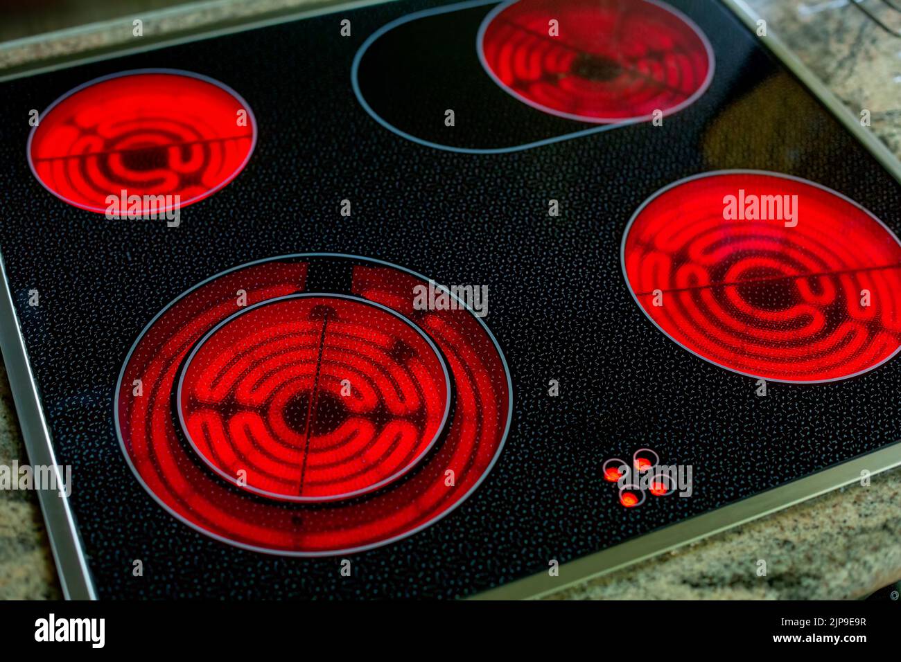 close-up of round red glowing induction stove Stock Photo
