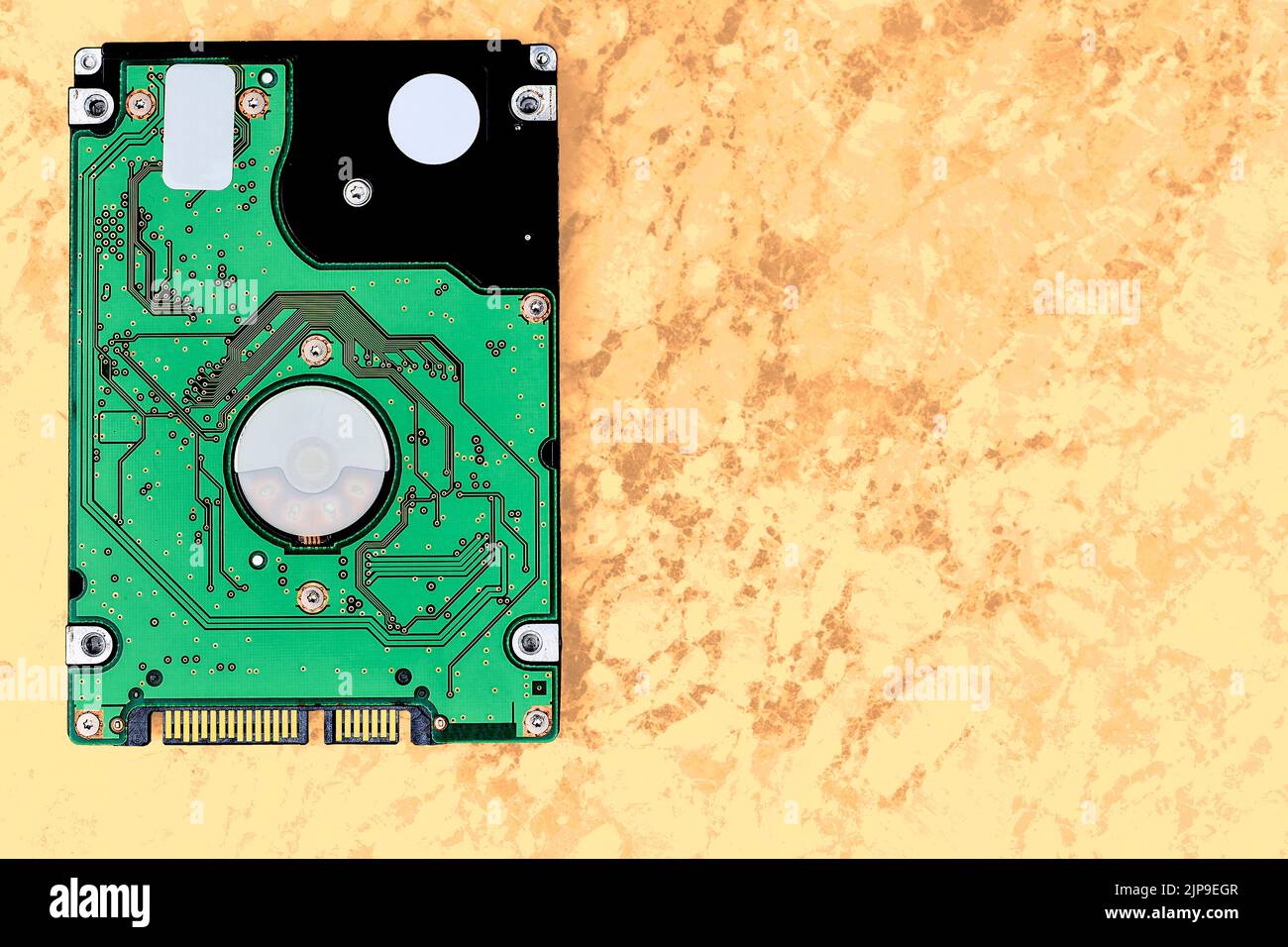 Internal hard drive for storing information on a yellow brown sandy