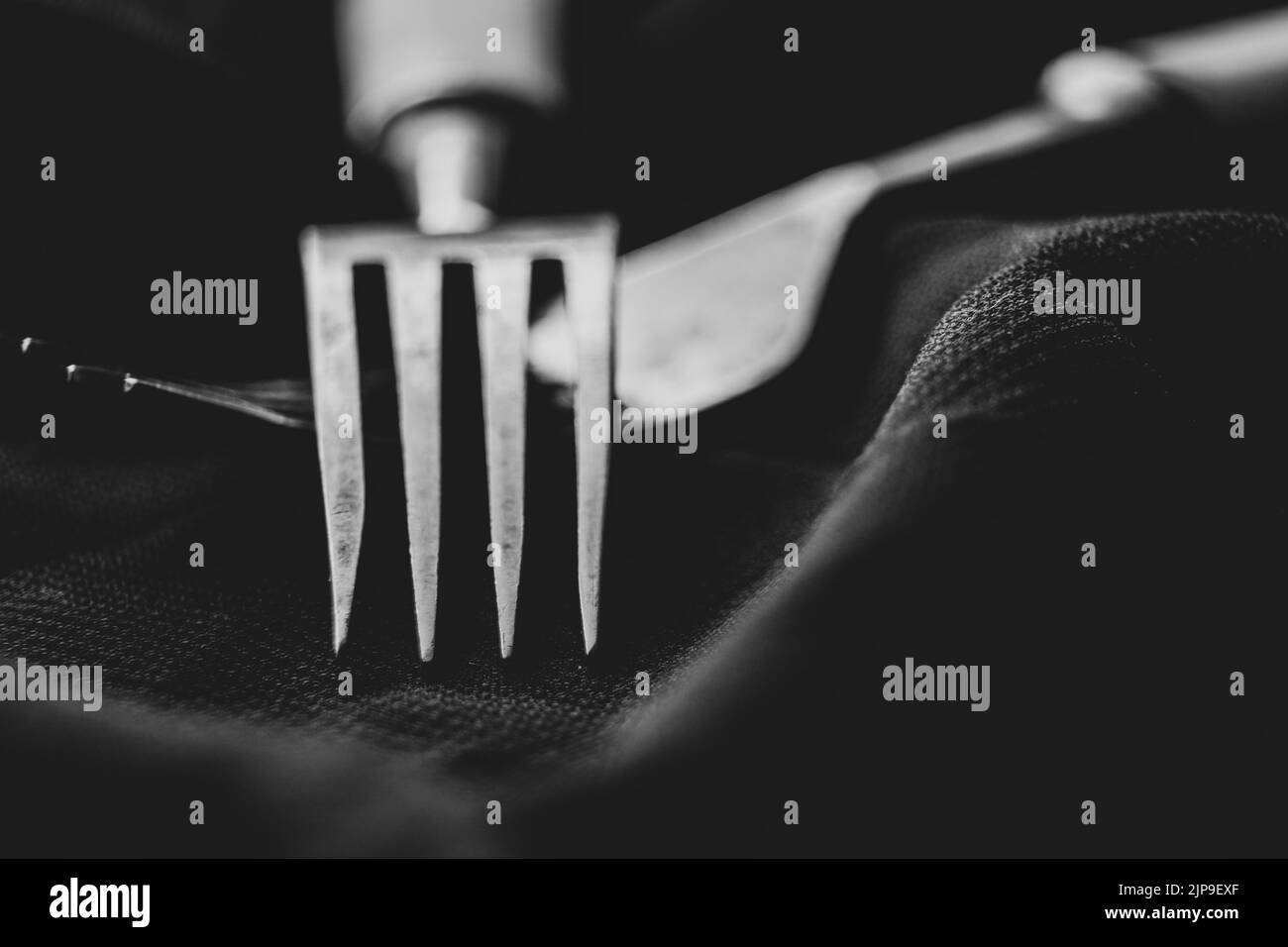 Old forks on a black background close-up, kitchen utensils, cutlery vintage Stock Photo