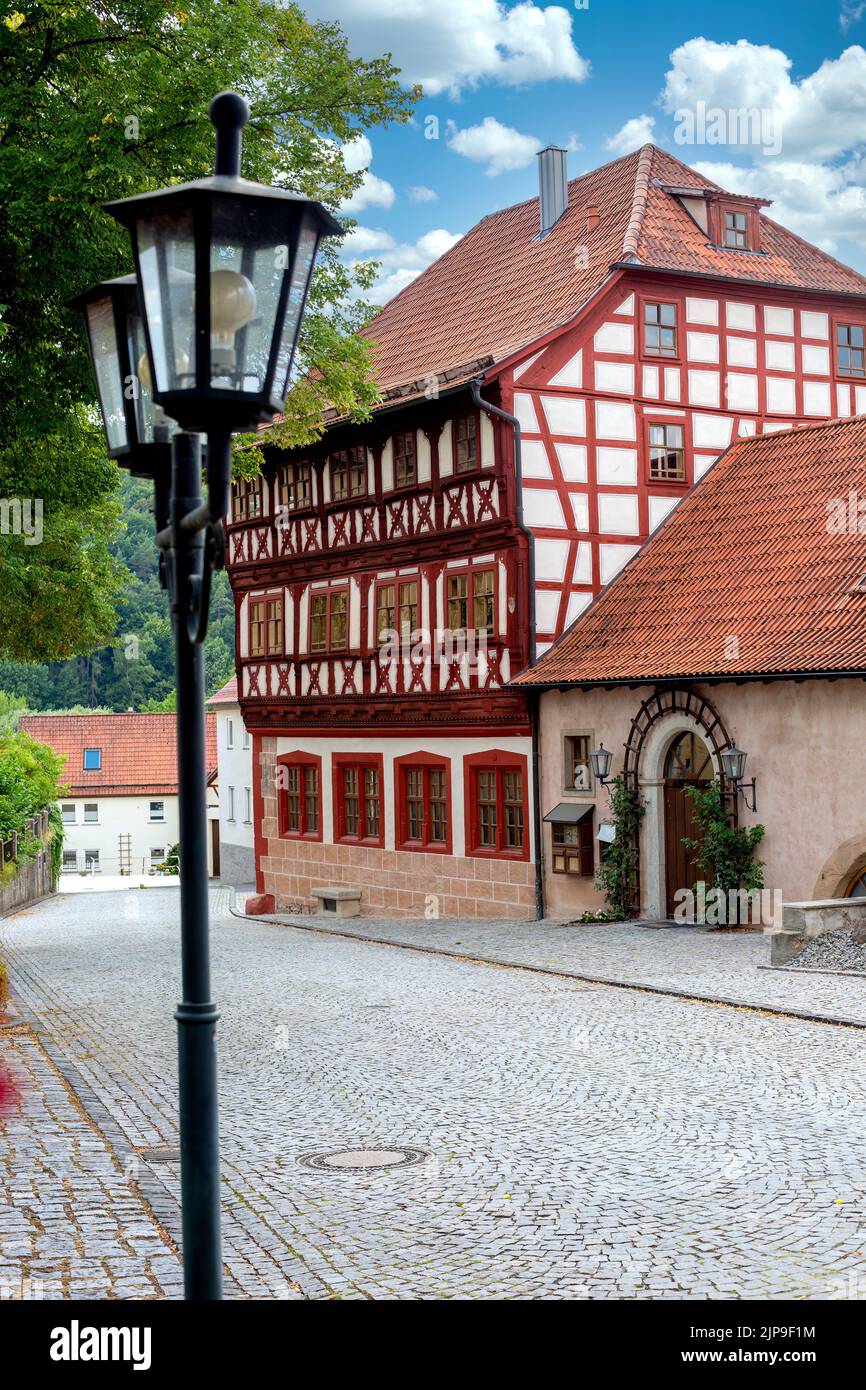 view of street and old historical half timbered house Stock Photo