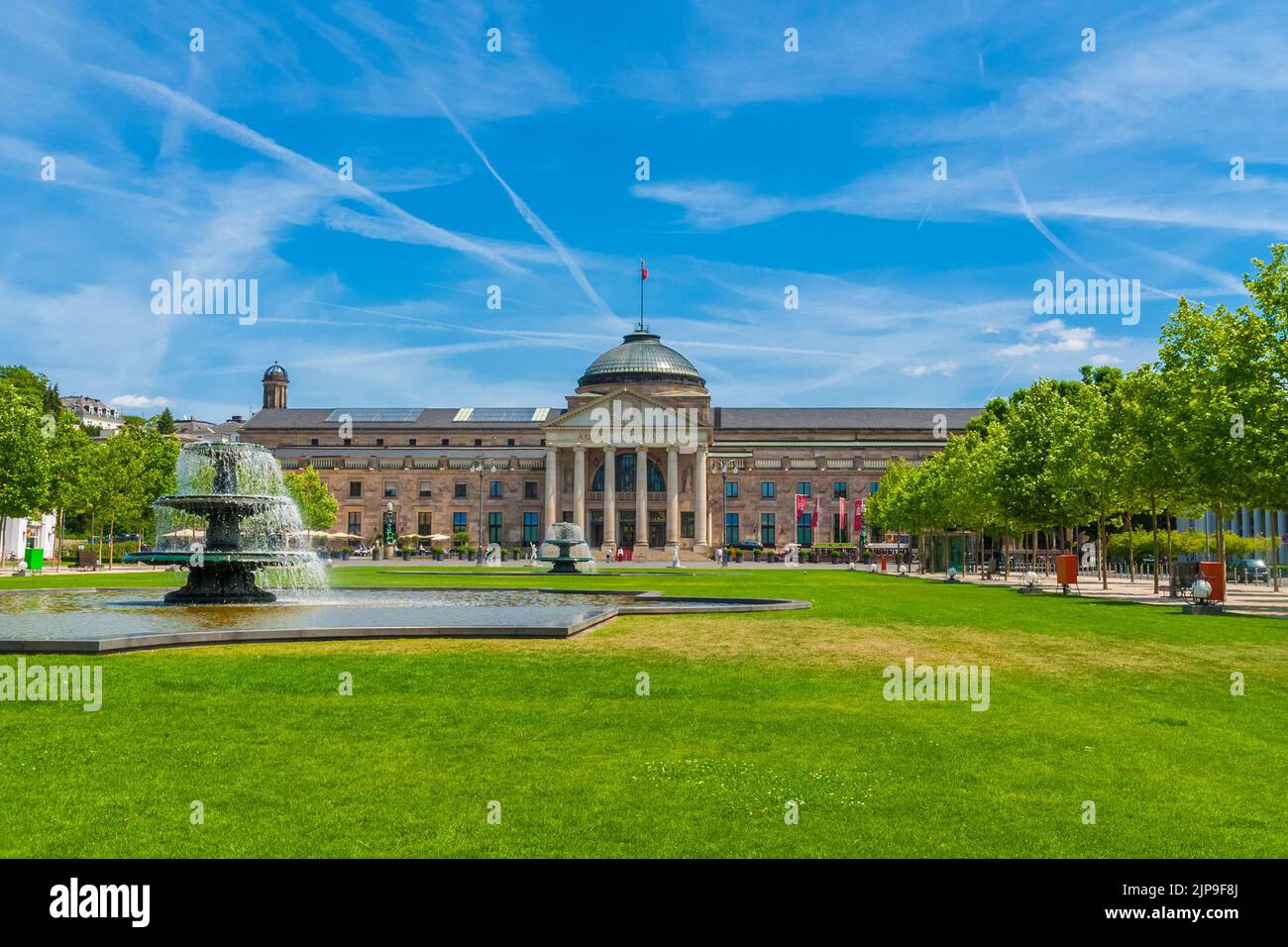 Picturesque view of the main entrance on the west side of Wiesbaden's Kurhaus (spa house) with the so-called Bowling Green, a grass-covered square wit Stock Photo