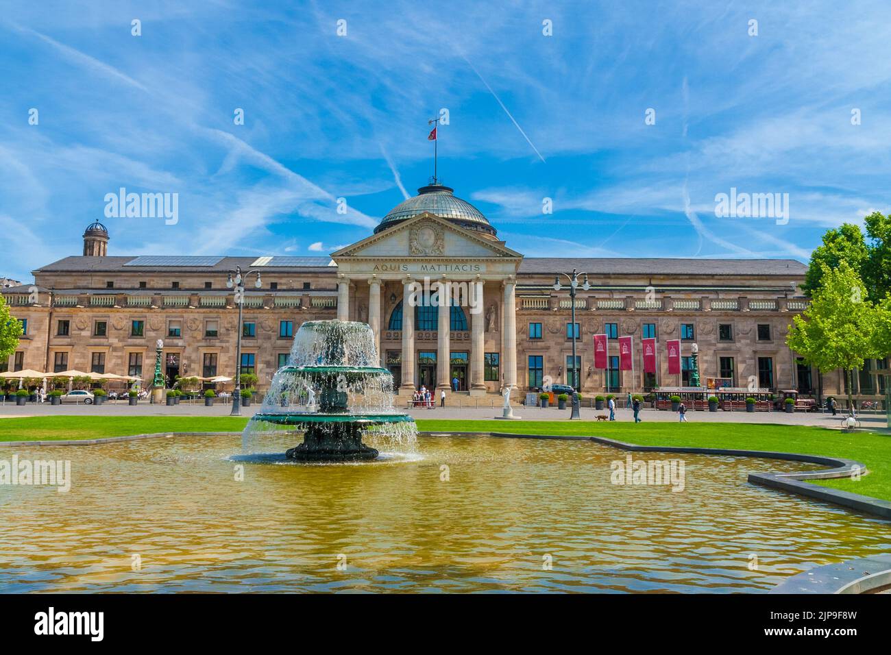 Beautiful view of the main entrance of Wiesbaden's Kurhaus (spa house) on the west side with a fountain in front. On the building's portal the words... Stock Photo