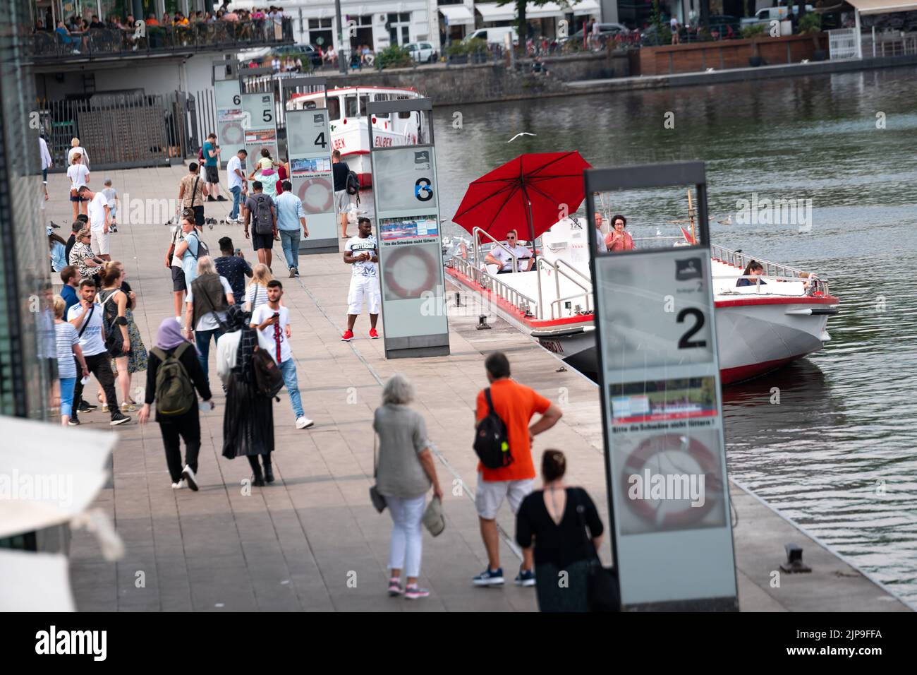 Hamburg, Germany. 16th Aug, 2022. Numerous people stroll in front of the Alster steamers on the Jungfernstieg at the Binnenalster. Credit: Jonas Walzberg/dpa/Alamy Live News Stock Photo