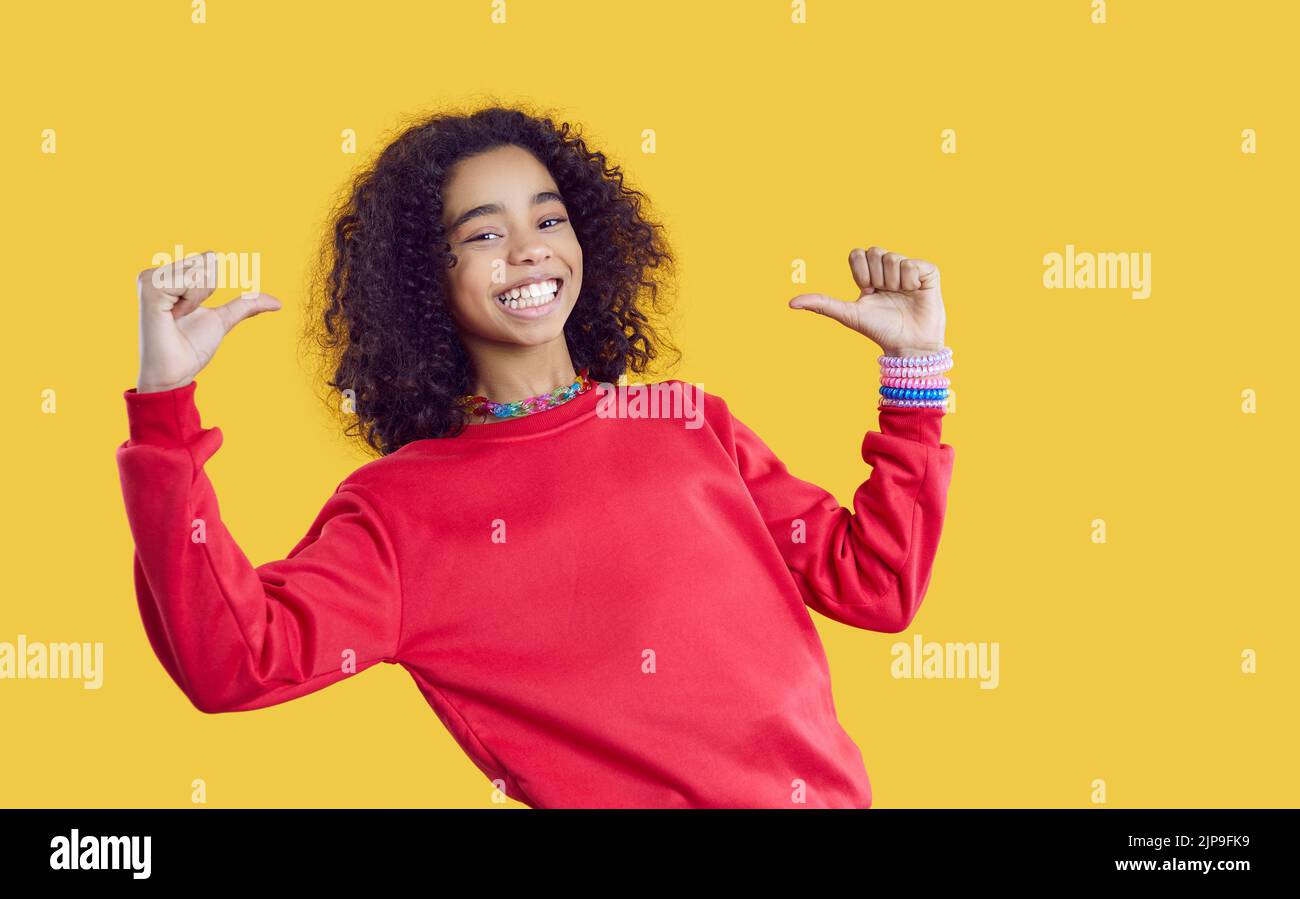 Smiling African American teenager point at herself Stock Photo