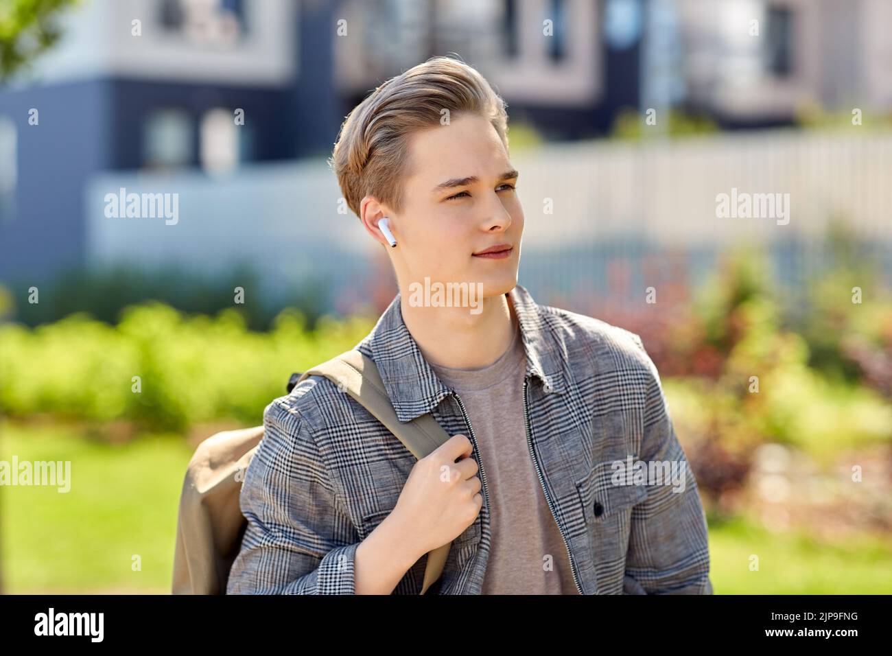 young man with earphones and backpack in city Stock Photo