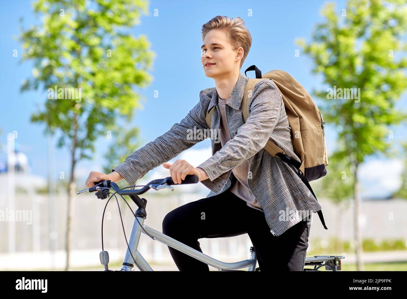 young man riding bicycle on city street Stock Photo