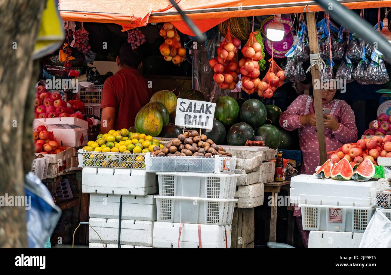 Vendor selling variety of local fruits in the market. Ternate