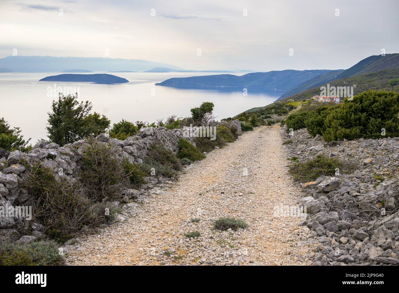 Old road near Predoscica (Cres, Croatia) on a cloudy day in springtime Stock Photo