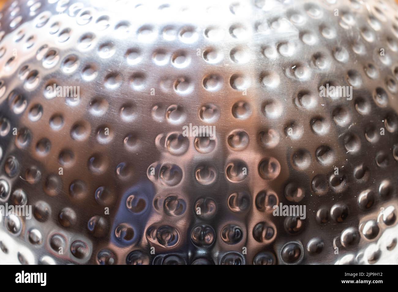 Metal surface with round dents in the surface Stock Photo - Alamy