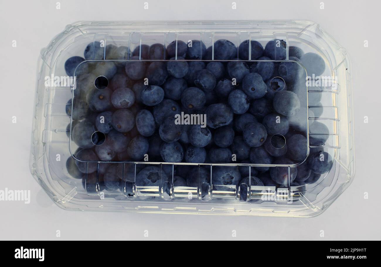 Strawberries in a plastic box for transport. Supermarket packaging. Too