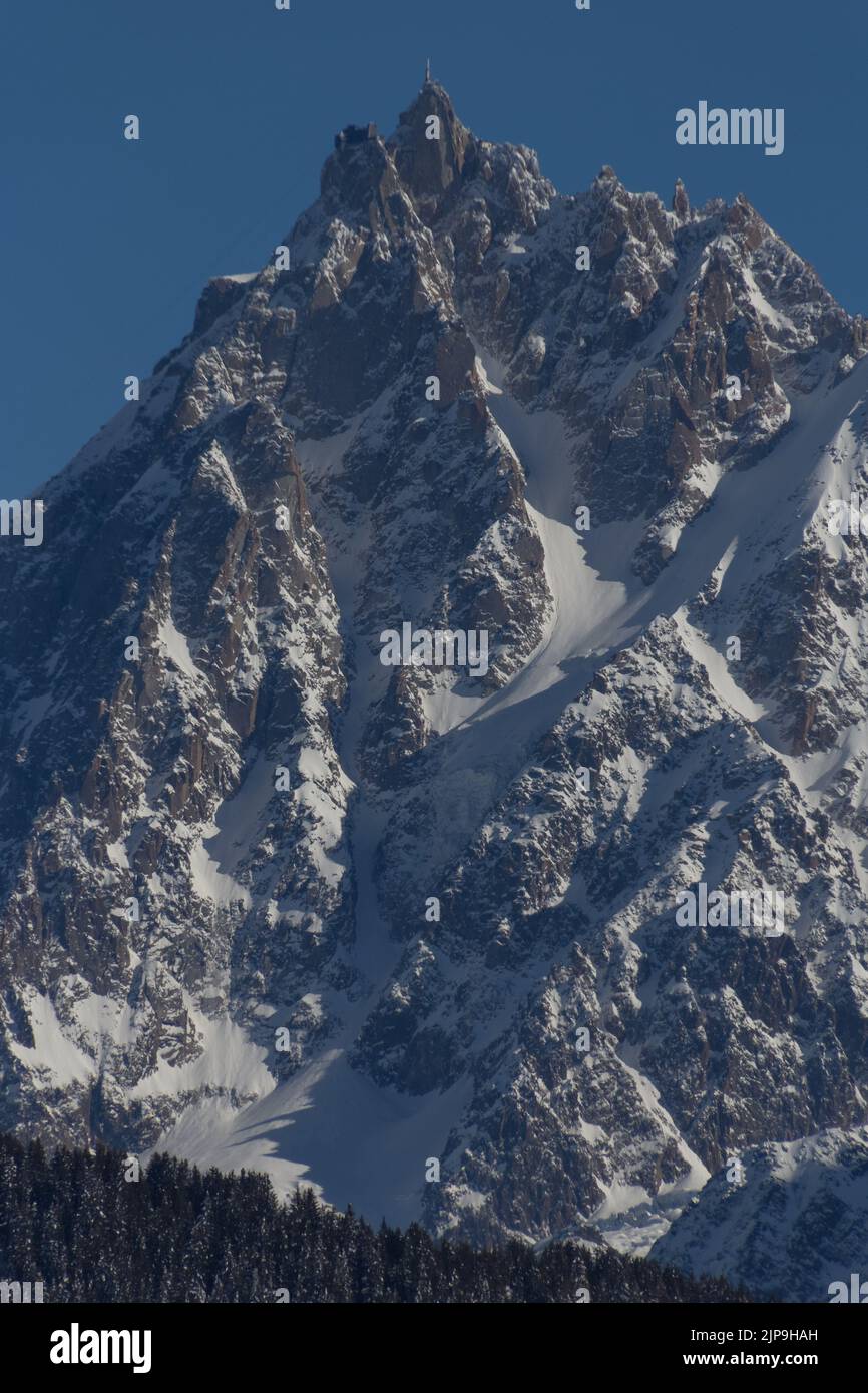 A vertical shot of the Aiguille du Midi mountain in the Mont Blanc ...