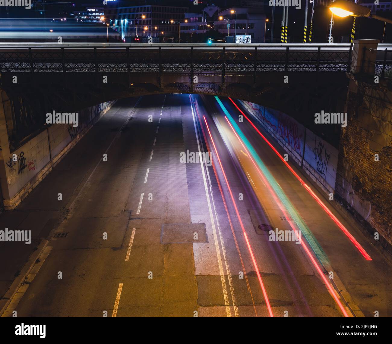 Cars at night on the road under the bridge. Night photo. Traffic ...