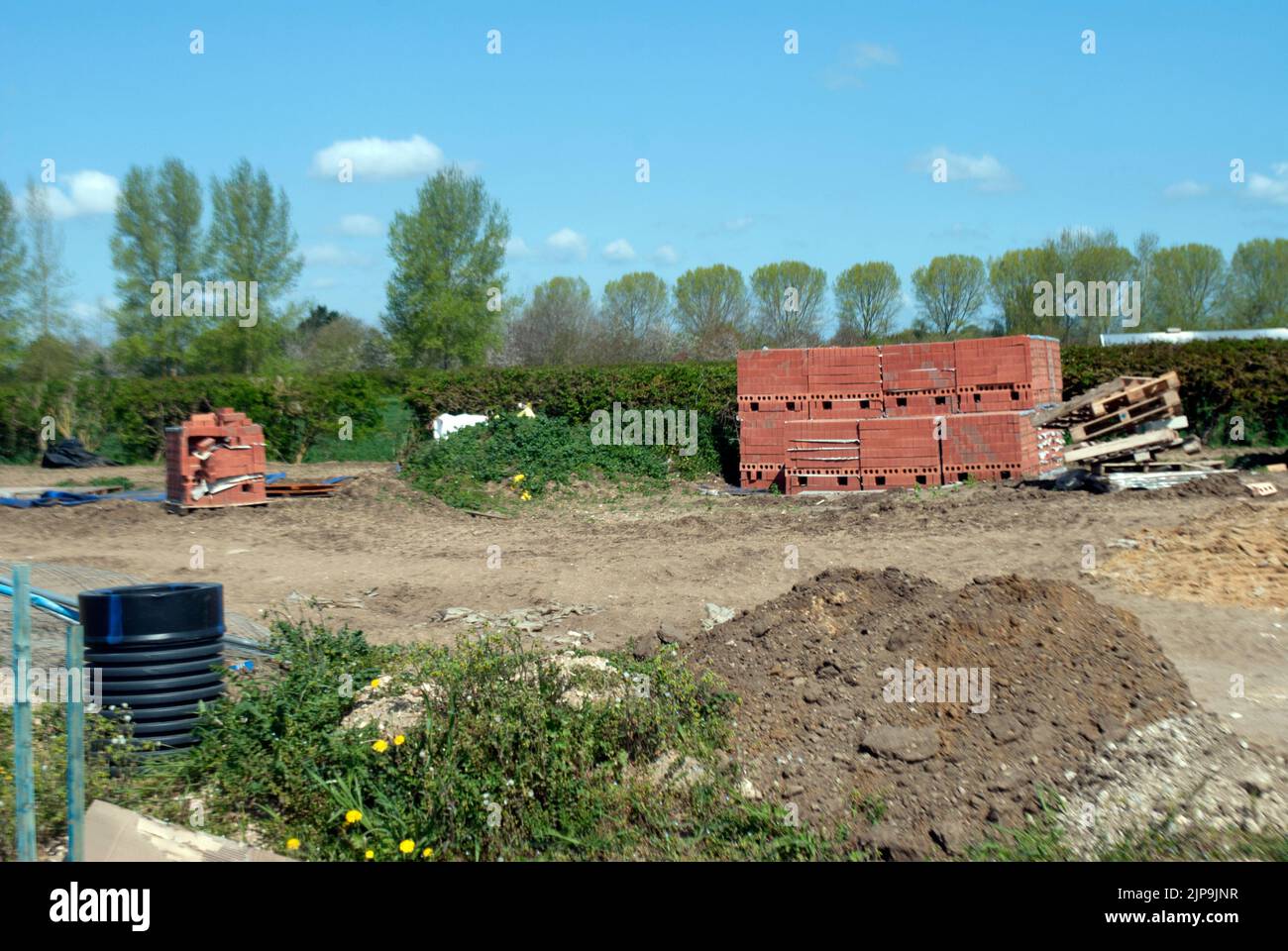 Stacked pallets of building materials on a building site Stock Photo