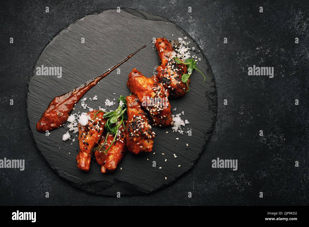 Barbecue chicken wings on a black stone Stock Photo Alamy