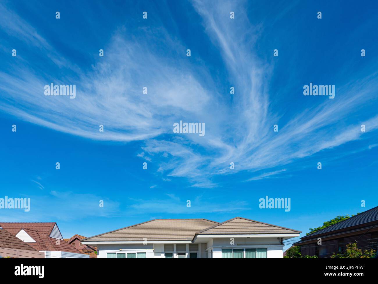 The roof of the house is in the weather on a sunny day with a clear sky. Stock Photo