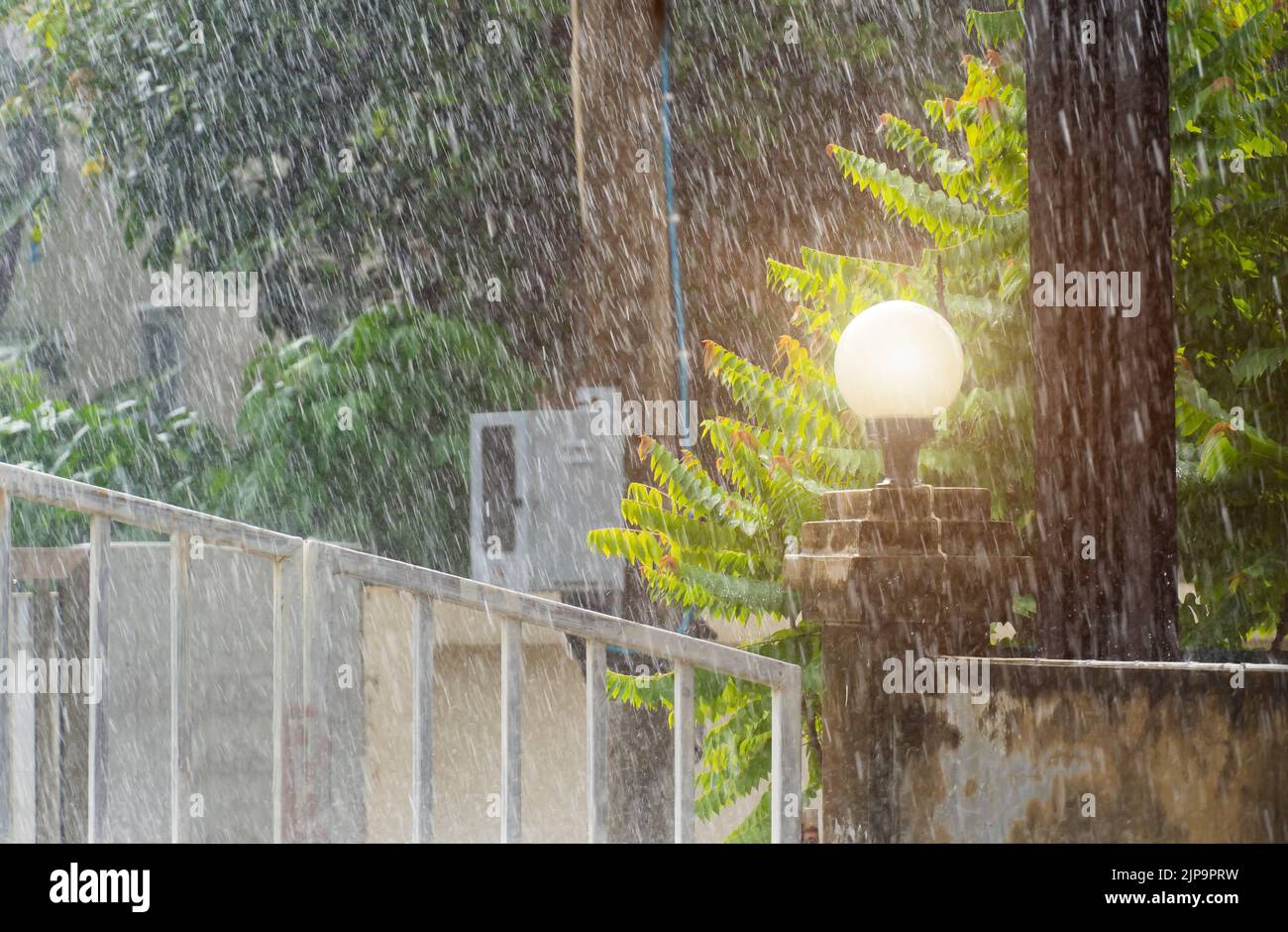 Summer rain storms fall on home and there is a strong wind Stock Photo ...