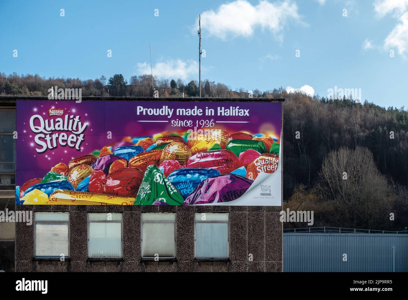 UK confectioners, Quality Street advert - Proudly made in Halifax since 1926 at Halifax railway station, West Yorkshire, England. Stock Photo