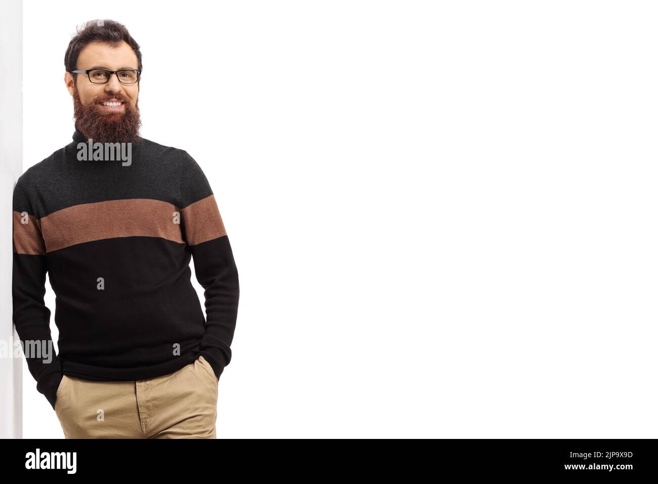 Man in a turtleneck cardigan leaning on a wall isolated on white background Stock Photo