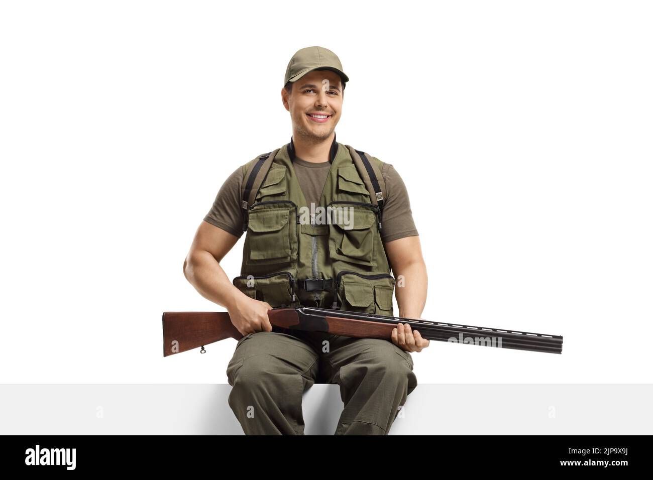 Hunter with a rifle sitting on a blank board isolated on white background Stock Photo