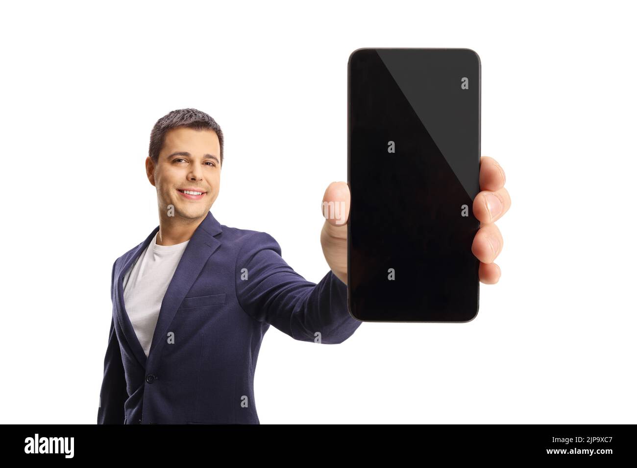 Man showing a blank screen of a smartphone in front of camera isolated on white background Stock Photo