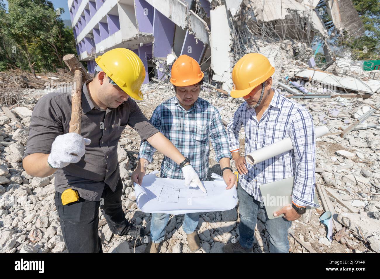 Engineer architect and worker operation control demolish old building ...