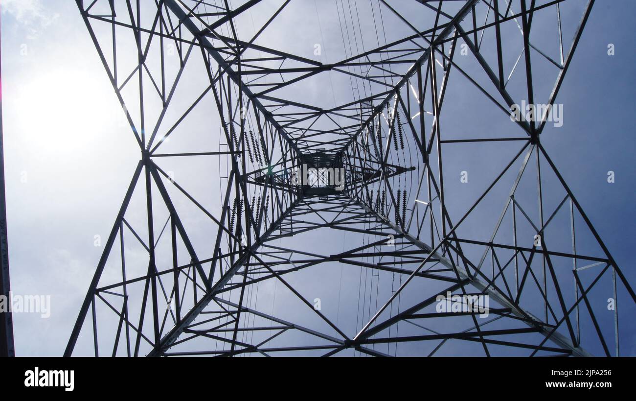 Inside if a high voltage power line tower Stock Photo - Alamy