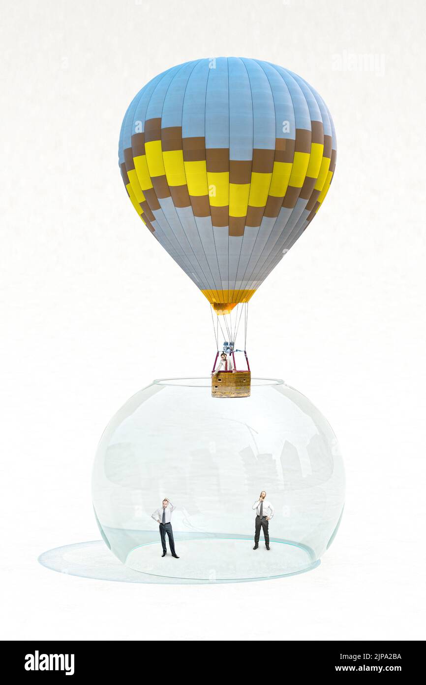 businessmen imprisoned in a glass bowl, one manages to get out thanks to a hot air balloon. Stock Photo