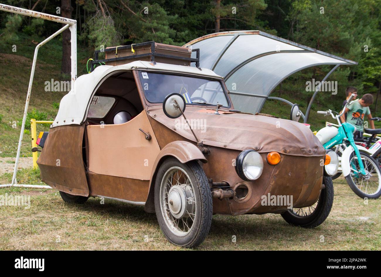 Classic Brown Original Three Wheeled Velorex Leather Cloth Car with a Roof Rack at Oldtimer classic car meeting Stock Photo