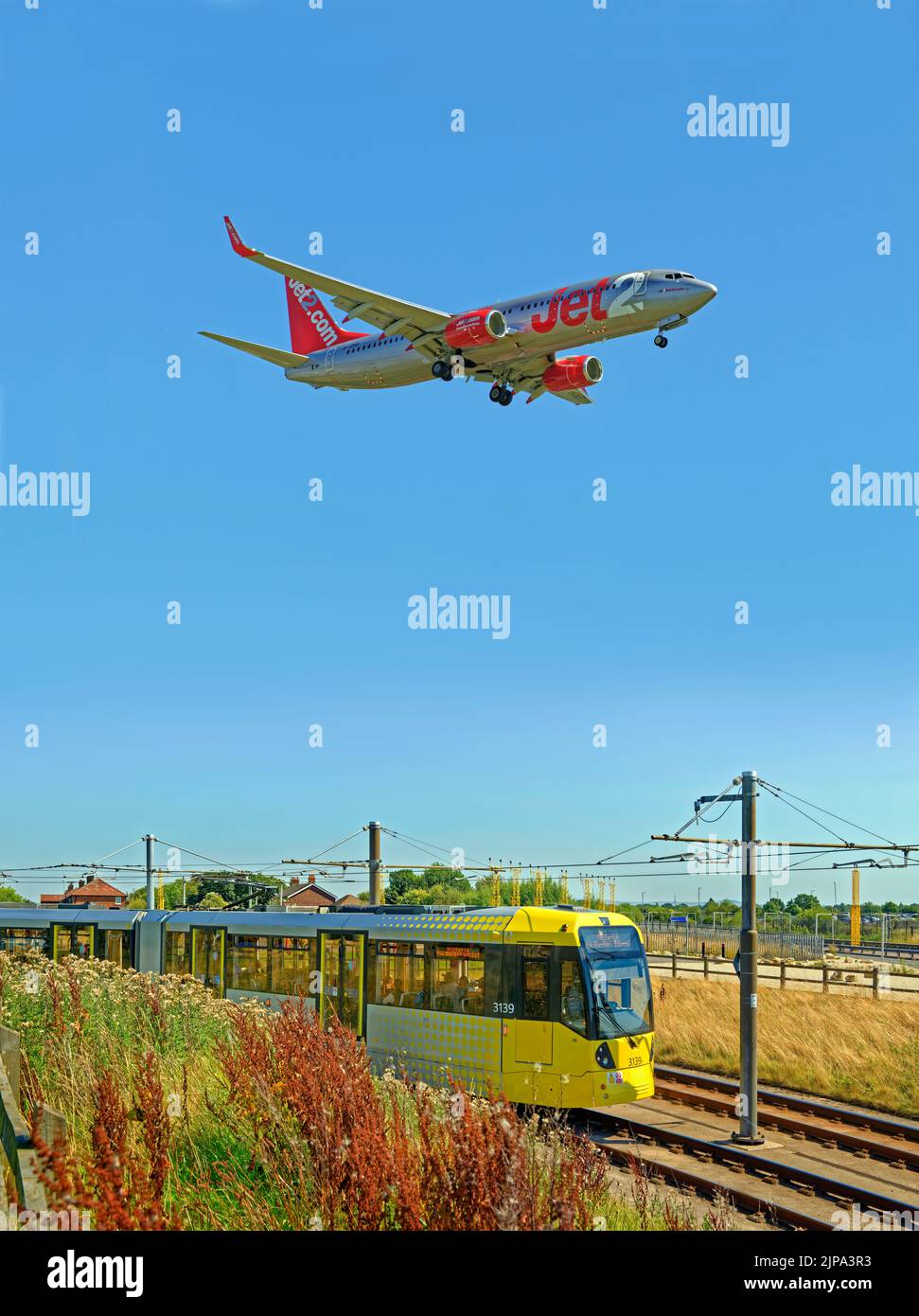 Manchester Metrolink tram approaching the Manchester Airport station, Manchester, England. Stock Photo