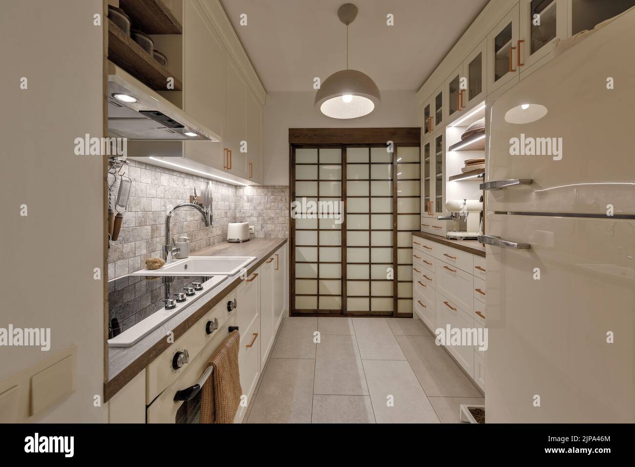 Modern Japandi kitchen interior design in earth tones, natural textures with wooden solid oak furniture and sliding Japanese wood doors. Japandi conce Stock Photo