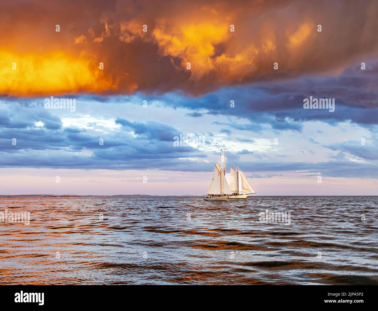 Two sail boats in West with an incredible sunset in Penobscot Bay Stock Photo