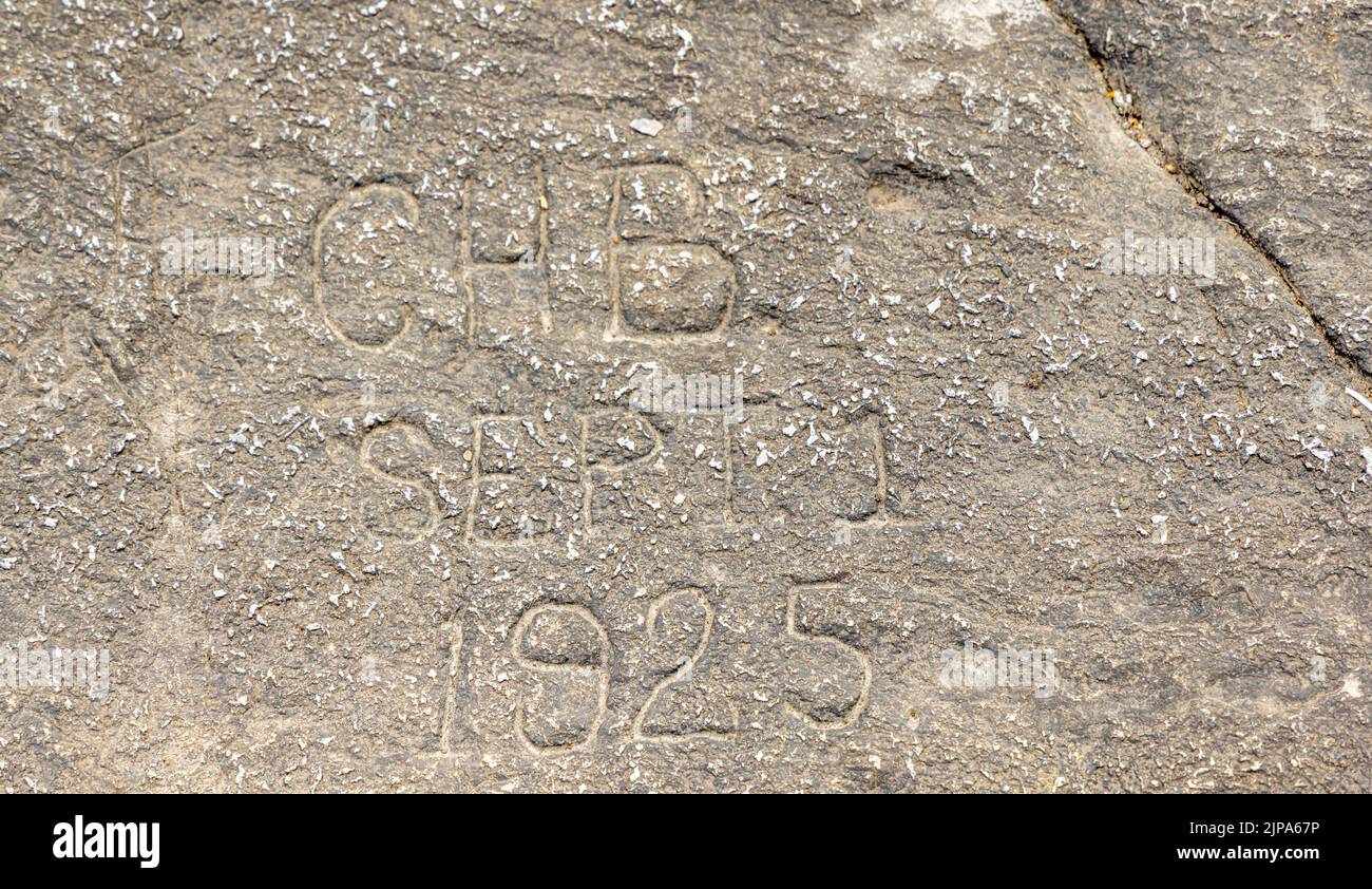Date and intials chiseled into a large rock on top of bald rock mountain Stock Photo