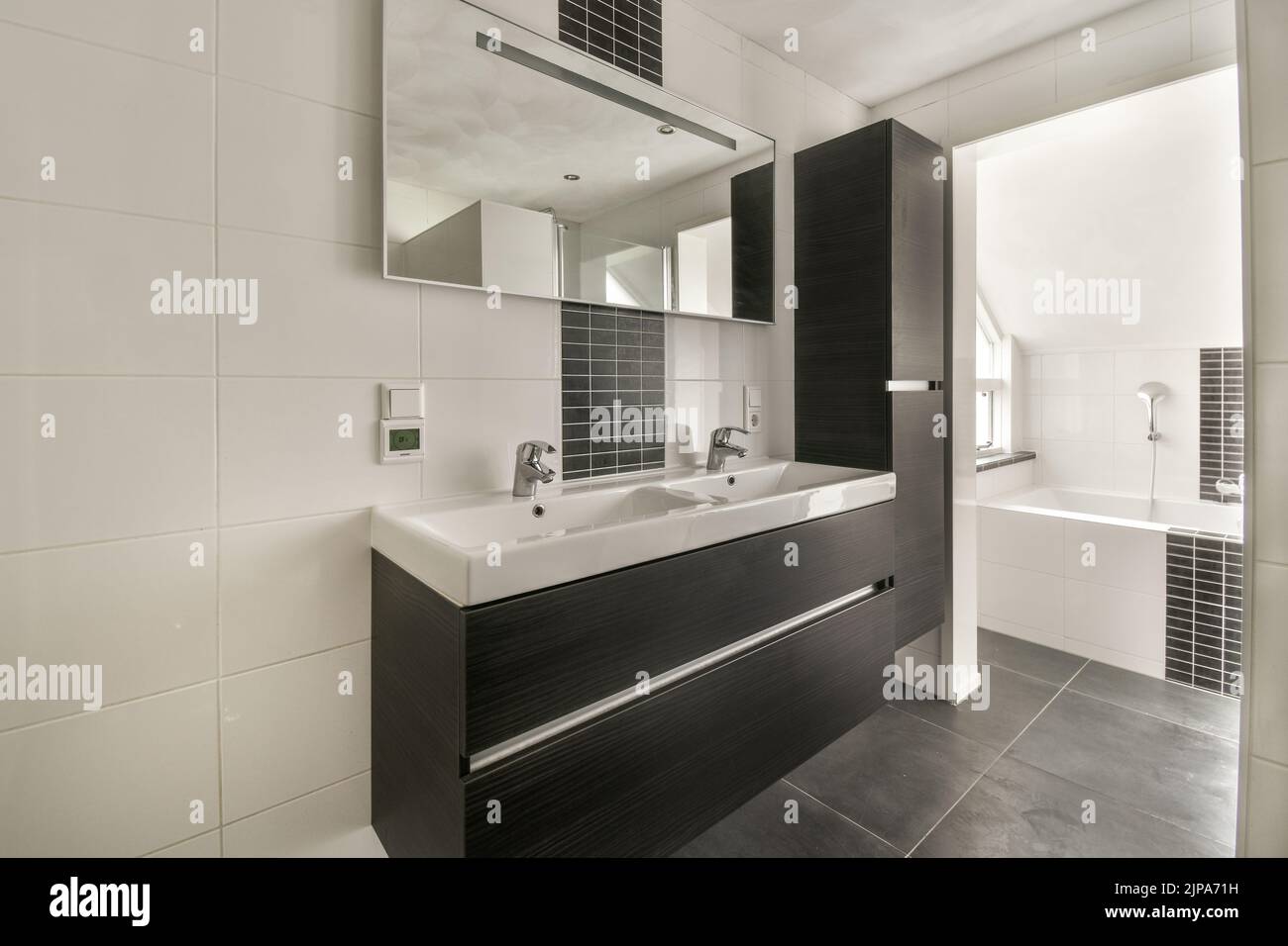 Modern home interior design of white bathroom with open bathtub and