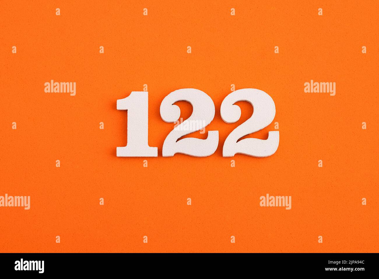 White wooden number 122 on eva rubber orange background Stock Photo - Alamy