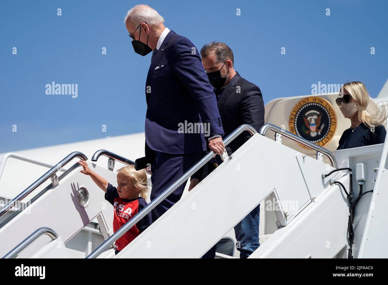 U.S. President Joe Biden walks from Air Force One with his grandson Beau Biden, son Hunter and daughter-in-law Melissa Cohen as he returns from Kiawah Island, South Carolina, at Joint Base Andrews in Maryland, U.S., August 16, 2022.      REUTERS/Joshua Roberts Stock Photo