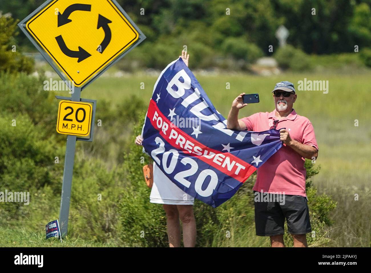 Supporters of U.S. President Joe Biden hold up signs as his motorcade passes through Kiawah Island, South Carolina, U.S., August 16, 2022.      REUTERS/Joshua Roberts Stock Photo