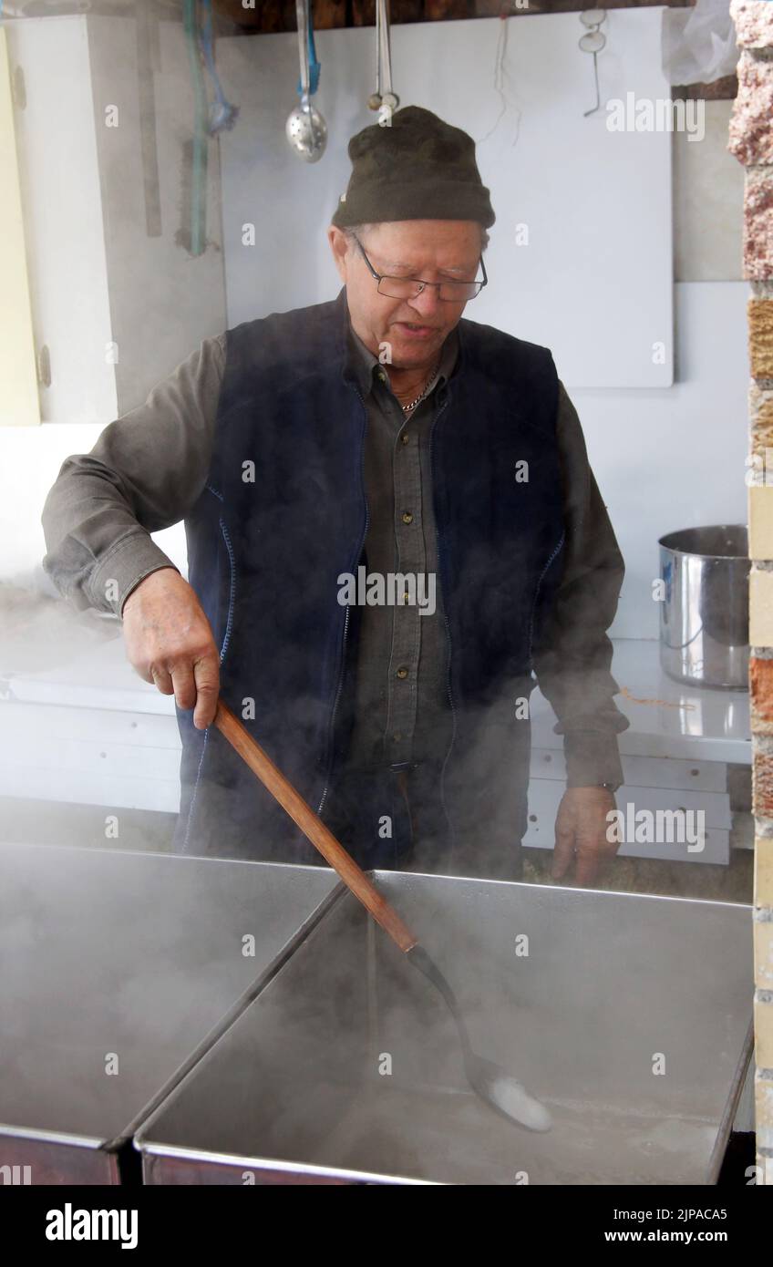 Senior man making home made artisan maple syrup Stock Photo