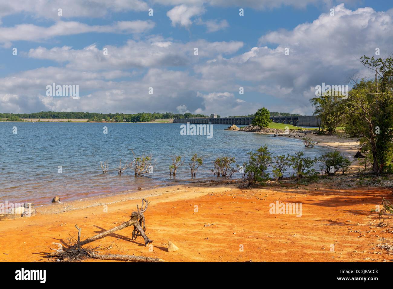 Sandy beach of Kerr Lake near Boydton in Virginia. view of the full length of the dam across the river Dan in the background. Stock Photo