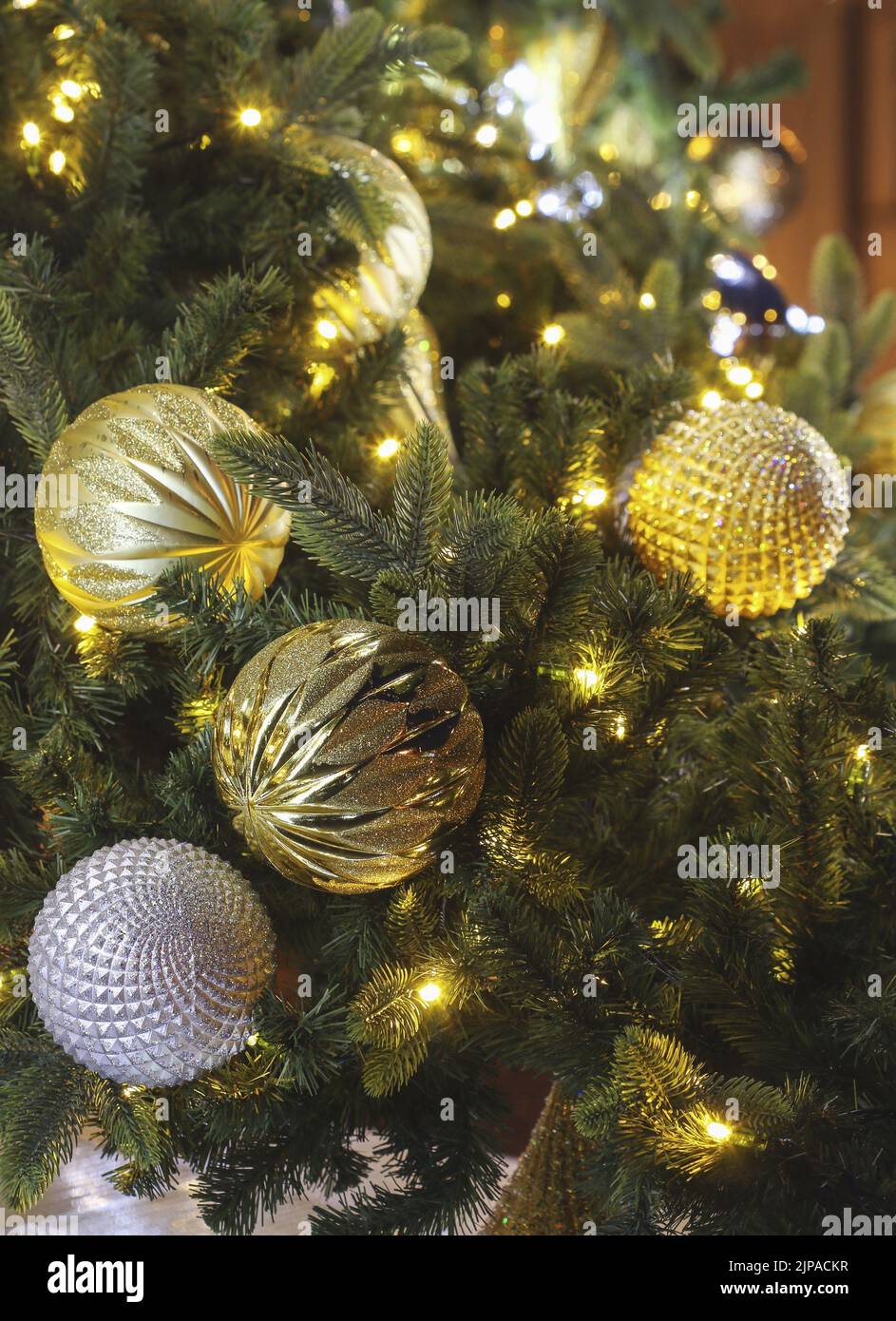 Outdoor Christmas tree decorated with golden baubles. Festive decor Stock Photo Alamy