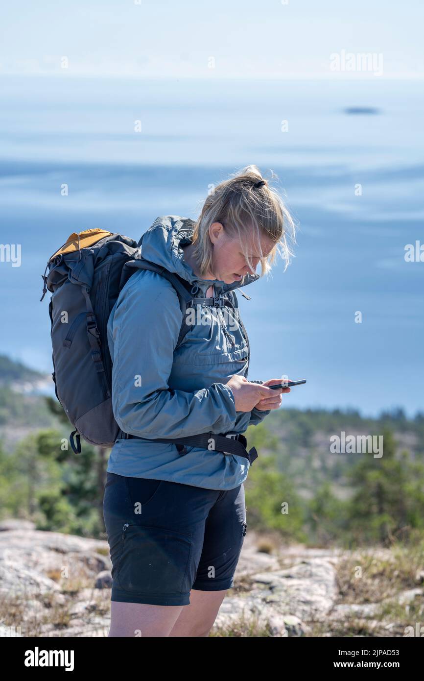 Lost and Worried young adult Woman searching for Mobile Phone coverage Stock Photo